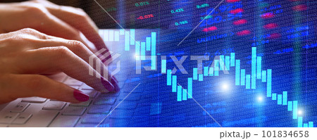 Trader at home working on laptop analyzing indexes, financial chart, graphs, investment and online trading 101834658