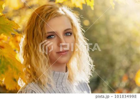 Portrait of attractive blond woman posing outdoors 101834998