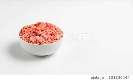 Plate with fresh ground beef on a white background, space for text, stock photo Plate with fresh ground beef on a white background, space for text, stock photo 101836344