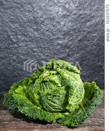 Raw, fresh savoy cabbage on wooden background, rustic concept Raw, fresh savoy cabbage on wooden background, rustic concept 101837873