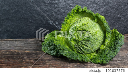 Raw, fresh savoy cabbage on wooden background, rustic concept Raw, fresh savoy cabbage on wooden background, rustic concept 101837876