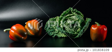 Fresh savoy cabbage and paprika on black background. Top view detox concept, vegan, food cooking ingredients Fresh savoy cabbage and paprika on black background. Top view detox concept, vegan, food cooking ingredients 101838109