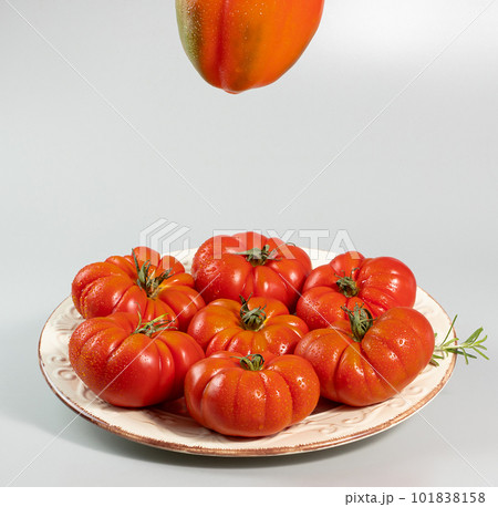 A group of Costoluto big tomatoes on a white background	 101838158