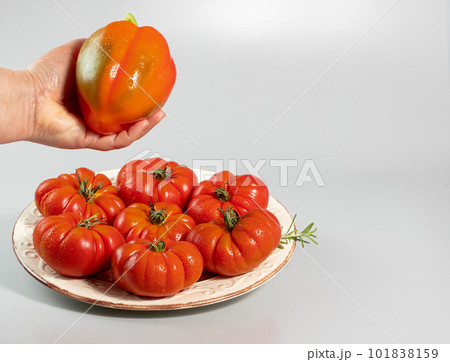 A group of Costoluto big tomatoes on a white background	 101838159