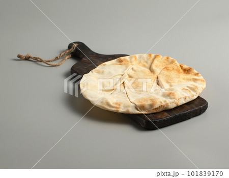 Traditional flatbread lavash on a wooden board, gray background, stock photo Traditional flatbread lavash on a wooden board, gray background, stock photo 101839170