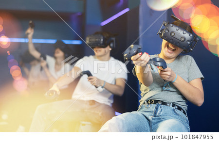 girl in virtual reality glasses controls superhero with joystick in exciting action game simulator 101847955
