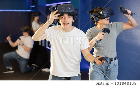 excited guy took off his virtual reality helmet to take little rest while VR play with girl excited guy took off his virtual reality helmet to take little rest while VR play with girl 101848138
