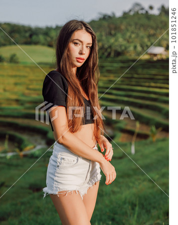 Young woman posing on rise terraces with sunlight at Bali island 101851246