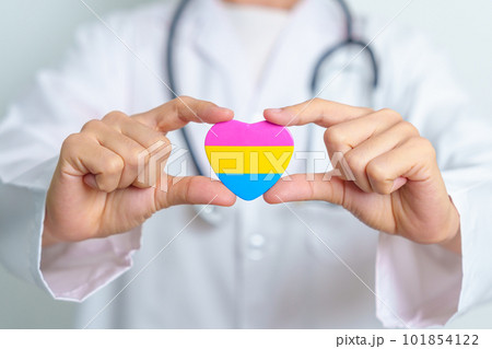 Pansexual Pride Day and LGBT pride month concept. Doctor hand holding pink, yellow and blue heart shape for Lesbian, Gay, Bisexual, Transgender, Queer and Pansexual community 101854122