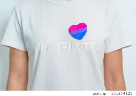Bisexuality Celebrate Day and LGBT pride month,  LGBTQ+ or LGBTQIA+ concept. Hand holding purple, pink and blue heart shape for Lesbian, Gay, Bisexual, Transgender, Queer and Pansexual community 101854129