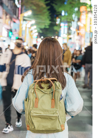 woman traveler visiting in Taiwan, Tourist with bag sightseeing and Shopping in Ximending street Market, landmark and popular attractions in Taipei city. Asia Travel and Vacation concept woman traveler visiting in Taiwan, Tourist with bag sightseeing and Shopping in Ximending street Market, landmark and popular attractions in Taipei city. Asia Travel and Vacation concept 101854228