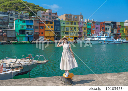 woman traveler visiting in Taiwan, Tourist with hat sightseeing in Keelung, Colorful Zhengbin Fishing Port, landmark and popular attractions near Taipei city . Asia Travel concept 101854234