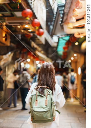 woman traveler visiting in Taiwan, Tourist with hat and backpack sightseeing and shopping in Jiufen Old Street market. landmark and popular attractions near Taipei city. Travel and Vacation concept 101854246