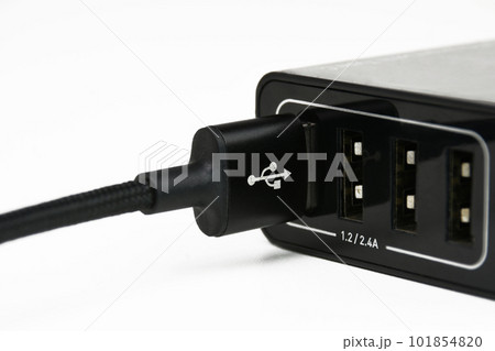 USB A charging cable in mobile phone charger port on white background 101854820