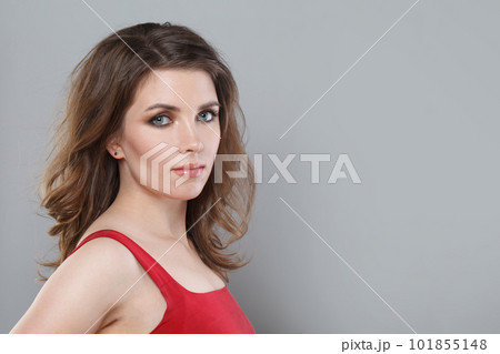 Stylish fashion model woman with makeup and long wavy hairdo closeup portrait. Pretty female face Stylish fashion model woman with makeup and long wavy hairdo closeup portrait. Pretty female face 101855148