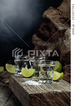 Tequila with salt and lime slices. 101857301