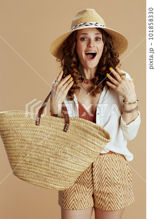 surprised female in blouse and shorts against beige 101858330