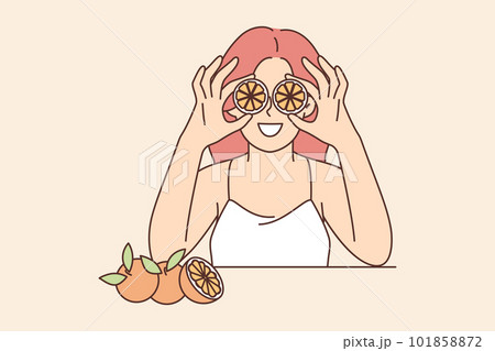 Woman holds slices of citrus fruit near eyes offering to use orange for rejuvenating facial mask 101858872