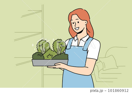 Smiling woman with microgreen container in hands Smiling woman with microgreen container in hands 101860912