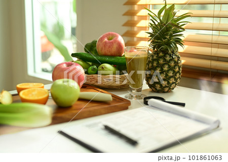 Fruit and vegetable on chopping board with Nutrition Facts on table. 101861063