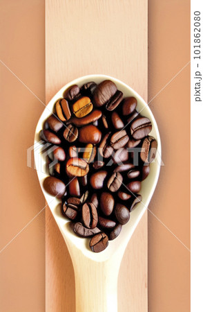 coffee beans in a wooden spoon 101862080