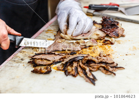 Chef slicing grilled beef steak Chef slicing grilled beef steak 101864623