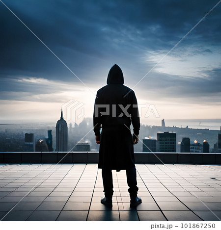 Hooded hacker on the roof of a building looking at the horizon with his back Hooded hacker on the roof of a building looking at the horizon with his back 101867250