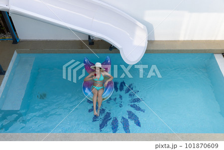 Woman in bikini with rubber inflatable float. Woman in swimsuit on the swim tube in swimming pool.  101870609
