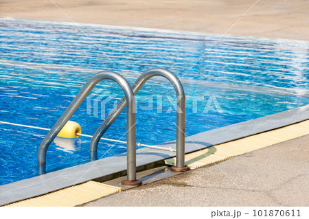 Ladder stainless handrails for descent into swimming pool. Swimming pool with handrail . Ladder stainless handrails for descent into swimming pool. Swimming pool with handrail . 101870611