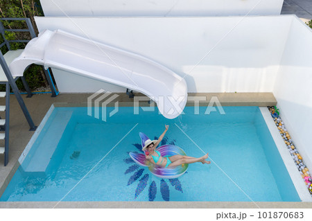 Woman in bikini with rubber inflatable float. Woman in swimsuit on the swim tube in swimming pool.  101870683
