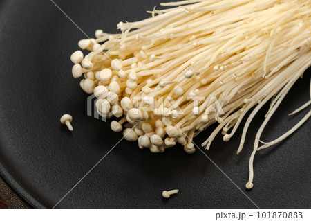 Popular in asian cuisine fresh needle mushroom or enoki, enokitake Flammulina velutipes. Popular in asian cuisine fresh needle mushroom or enoki, enokitake Flammulina velutipes. 101870883