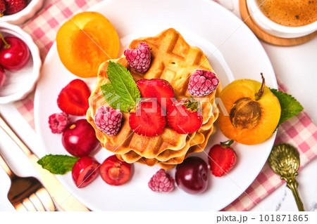 Belgian waffles with strawberries, apricots, cherries, juice 101871865