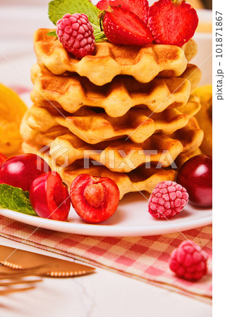 Stack of belgian waffles with fresh strawberries 101871867