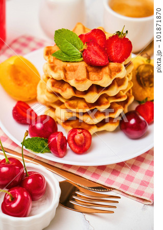 Stack of belgian waffles with fresh strawberries 101871870