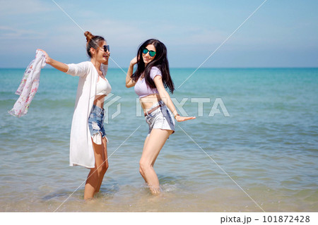 Happy female couple or bisexual couple enjoy walking along the beach together, women holding a hands together and running along the beach. LGBTQ people concept. 101872428