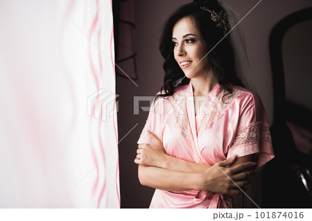 Luxury bride in white dress posing while preparing for the wedding ceremony Luxury bride in white dress posing while preparing for the wedding ceremony 101874016