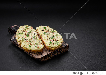 Grilled toast with avocado paste, eggs, cream cheese, salt, spices and herbs 101874668