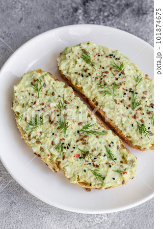 Grilled toast with avocado paste, eggs, cream cheese, salt, spices and herbs Grilled toast with avocado paste, eggs, cream cheese, salt, spices and herbs 101874675