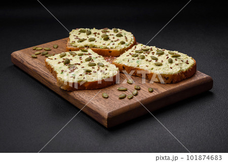 Grilled toast with avocado paste, eggs, cream cheese, salt, spices and herbs Grilled toast with avocado paste, eggs, cream cheese, salt, spices and herbs 101874683