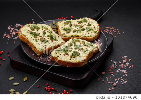 Grilled toast with avocado paste, eggs, cream cheese, salt, spices and herbs Grilled toast with avocado paste, eggs, cream cheese, salt, spices and herbs 101874690