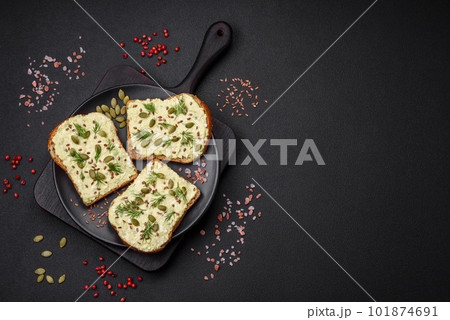 Grilled toast with avocado paste, eggs, cream cheese, salt, spices and herbs Grilled toast with avocado paste, eggs, cream cheese, salt, spices and herbs 101874691