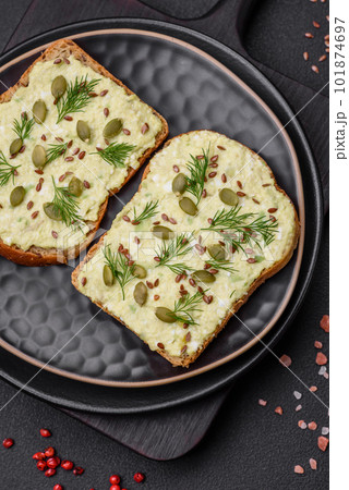 Grilled toast with avocado paste, eggs, cream cheese, salt, spices and herbs Grilled toast with avocado paste, eggs, cream cheese, salt, spices and herbs 101874697