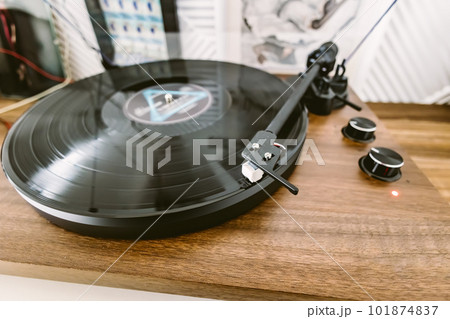 Vinyl record player, bright lights disco-bokeh. Needle on vinyl record. 101874837