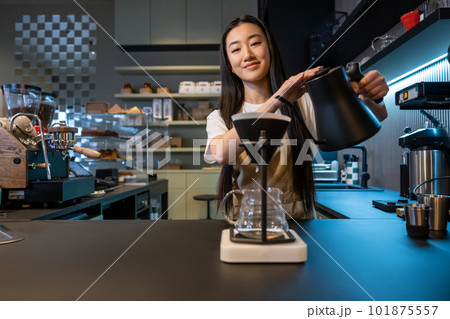 Happy bartender posing for the camera at work 101875557