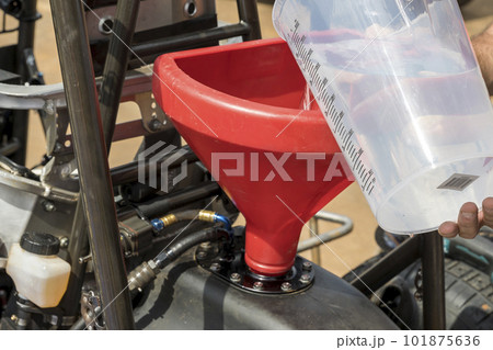 Filling the fuel tank on a speedway racing car in the pits 101875636