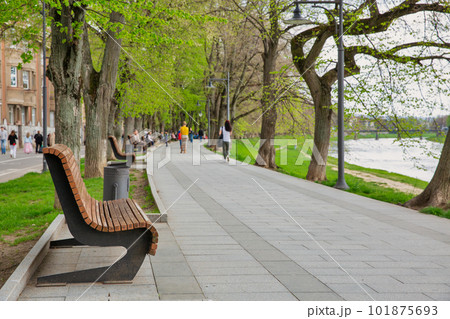 People walk on embankment of the Uzh river. Uzhhorod, Ukraine. People walk on embankment of the Uzh river. Uzhhorod, Ukraine. 101875693