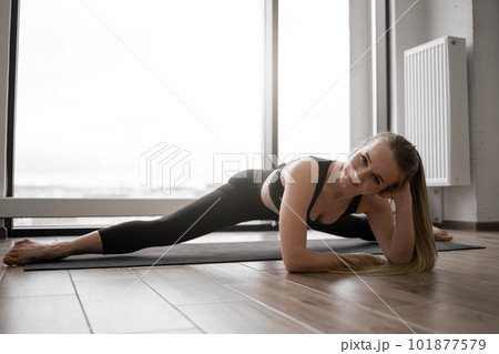 Female doing Upavistha Konasana during workout in studio 101877579
