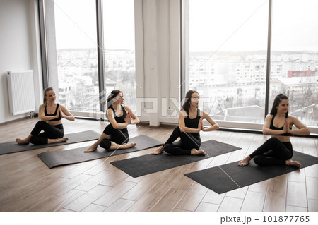 Ladies meditating in seated pose with hands in anjali mudra 101877765