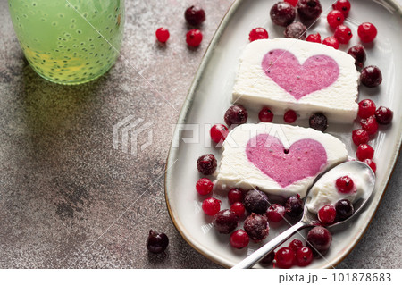 delicious ice cream with berry heart filling in middle and chia seeds water. healthy summer dessert. close-up 101878683