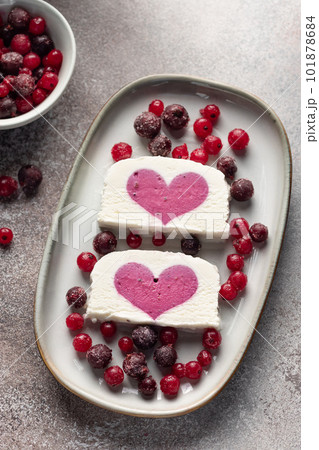 delicious ice cream with berry filling in ceramic plate. Summer refreshing ice cream dessert. vertical image delicious ice cream with berry filling in ceramic plate. Summer refreshing ice cream dessert. vertical image 101878684